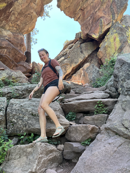 Rachel climbing down rocks.